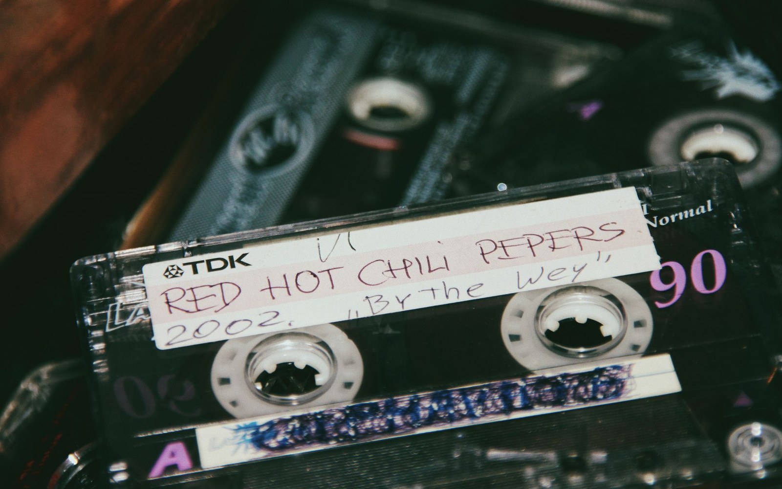 A TDK cassette tape labeled by hand "Red Hot Chili Peppers, By the Way, 2002"